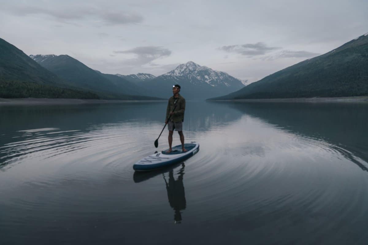Paddle Boarder in Front of Mountains